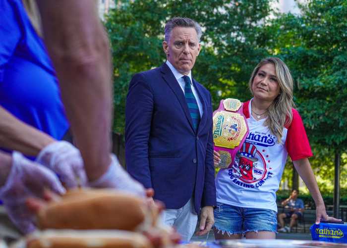 Host George Shea (left) and women’s champion Miki Sudo.