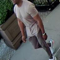 police photo of many wearing T-shirt and green pants wanted for assault on uptown A train
