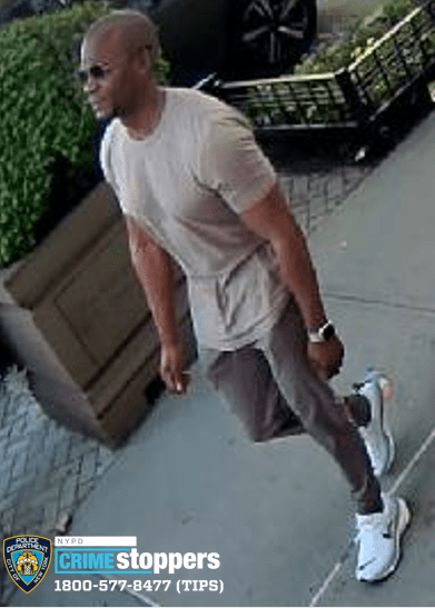 police photo of many wearing T-shirt and green pants wanted for assault on uptown A train