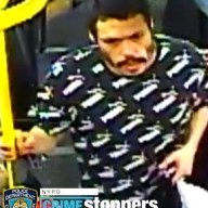 man in black and white shirt on a bus in Brooklyn