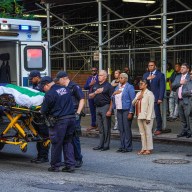 EMS transports 32-year-old police recruit Edgar Ordonez away, while police and officials hold their hands over their hearts.