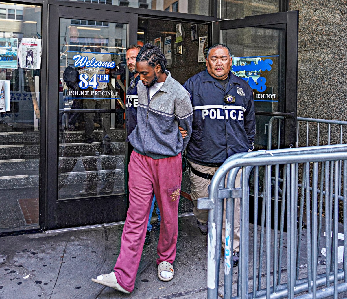 The group were whisked away in cuffs to 84th Precinct where all five alleged scam artists were piled into unmarked police vans.
