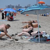 Man builds sandcastle on NYC beach during heat wave