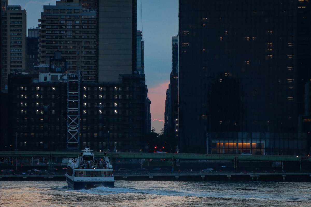 The sun sets on Manhattanhenge 2024 with cloud coverage obstructing the view 2