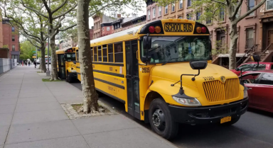 Yellow school buses sit outside PS K140 in Bedford-Stuyvesant, Brooklyn in 2022.