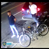 two men standing near bikes in Brooklyn