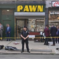 Brooklyn police officer stands guard outside shooting scene