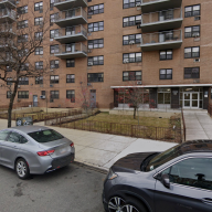 Bronx apartment building with car parked in front