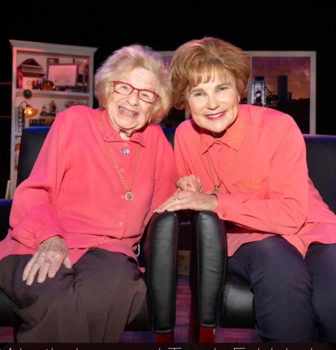 Actress who played Dr. Ruth in one-woman show says beloved friend and sex therapist 'left the world a better place' 2 two women wearing the same color pink dress, sitting in chairs