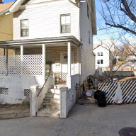two houses painted in a light color on a clear day during the day in the Bronx