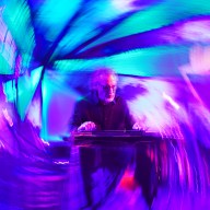Jonathan Gregg performing on steel guitar with swirling background