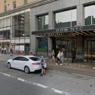 woman wearing white T-shirt next to a scene of Midtown Manhattan
