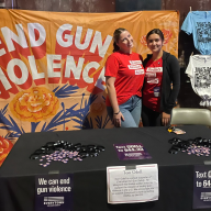 two teenagers at a table advocating for gun violence prevention