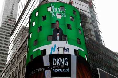 Jason Robins, CEO of DraftKings, is displayed at the Nasdaq MarketSite jumbotron, before the company debuts its initial public offering (IPO) listing, in New York City