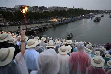 Paris 2024 Olympics - Opening Ceremony - Paris, France - July 26, 2024. Boats carrying members of delegations sail along the Seine during the opening ceremony of the Paris 2024 Olympic Games.