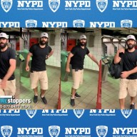 man wearing black shirt, tan shorts and hat in Midtown