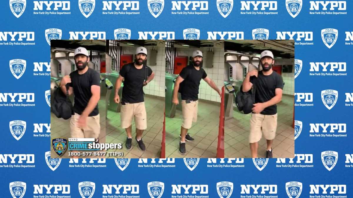 man wearing black shirt, tan shorts and hat in Midtown