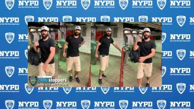man wearing black shirt, tan shorts and hat in Midtown