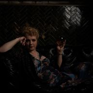 a woman in the spirits speakeasy with a crystal ball