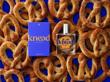 Auntie Anne's new perfume resting on top of a pile of pretzels