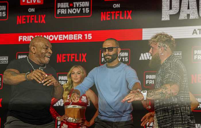 Mike Tyson and Jake Paul have a shoving match.