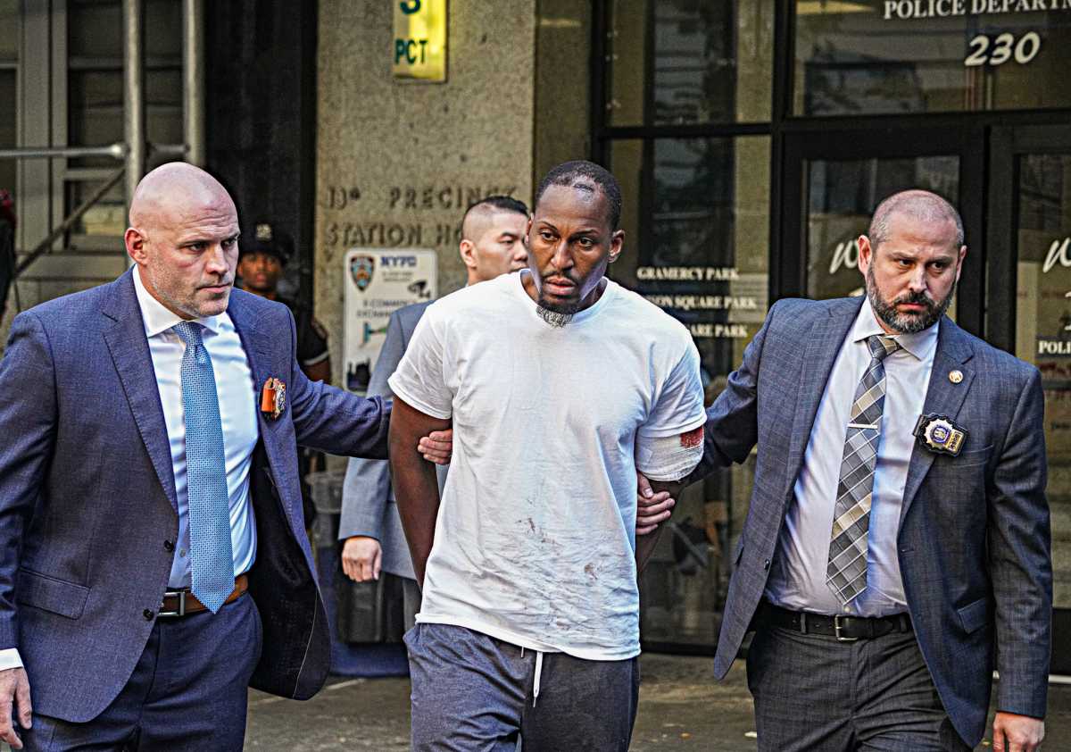 The man who allegedly beat a Manhattan pizzeria worker so severely he remains clinging to life Tuesday said he was “sorry” after being cuffed by police.