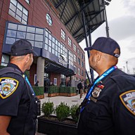 NYPD officers look at Arthur Ashe Stadium during the US Open