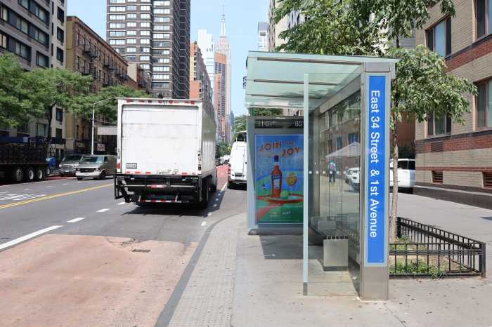 A truck blocks the bus lane on 34th Street on Aug. 15, 2024, ironically, during a press conference on bus camera enforcement.