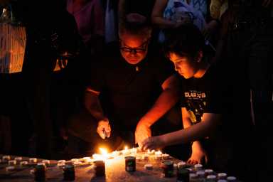 People light candles for hostages killed by Hamas, during a vigil at Columbus Circle on Sunday, Sept. 1, 2024.