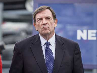 Ex NYPD commissioner Tom Donlon smirking at camera