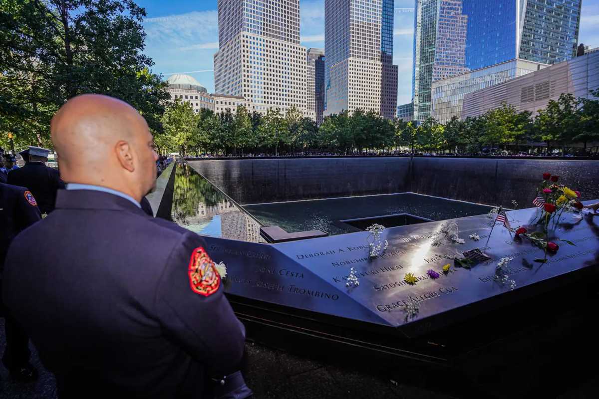 A firefighter stands at the 9/11 Memorial on Sept. 11, 2024.