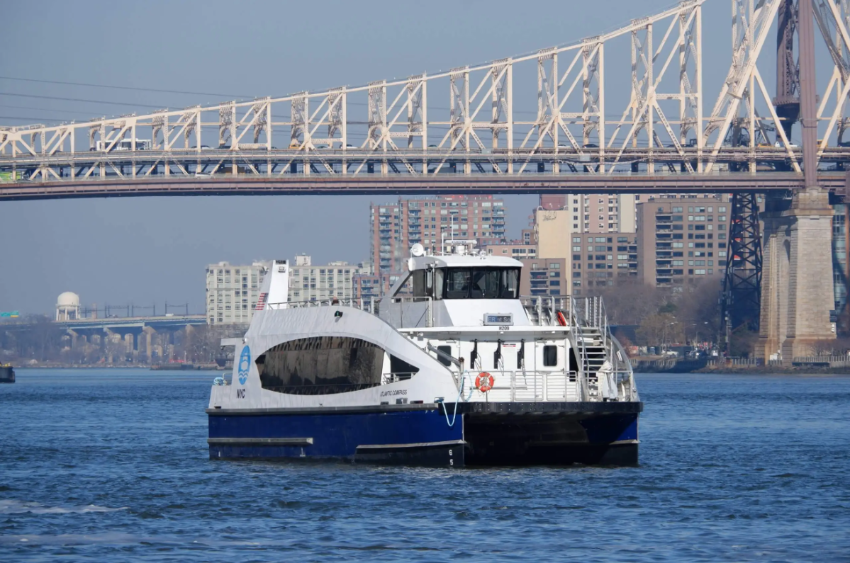 An NYC Ferry on the East River near the Queensboro Bridge in 2022.