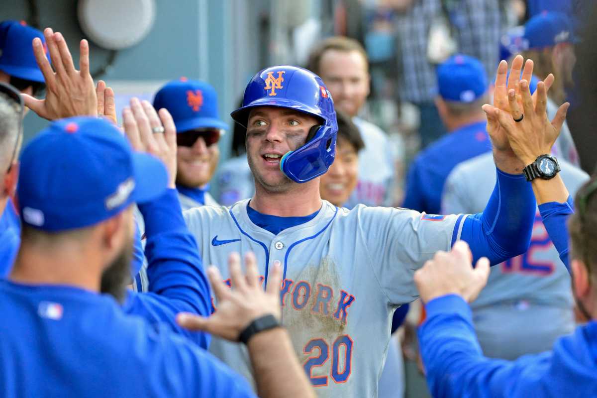 New York Mets first baseman Pete Alonso (20) celebrates in the dugout after scoring in the ninth inning against the Los Angeles Dodgers during game two of the NLCS for the 2024 MLB Playoffs at Dodger Stadium.