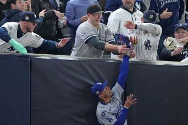 Angeles Dodgers outfielder Mookie Betts (50) makes a catch in foul terriotory against the New York Yankees in the first inning during game four of the 2024 MLB World Series at Yankee Stadium.