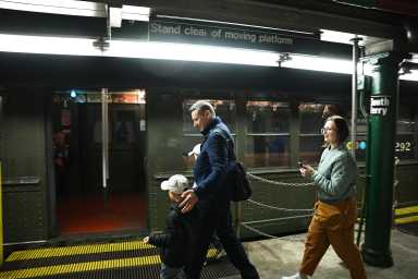 A family gets on the 1917 Lo-V train at the old South Ferry station on Oct. 27, 2024, the 120th birthday of the subway.
