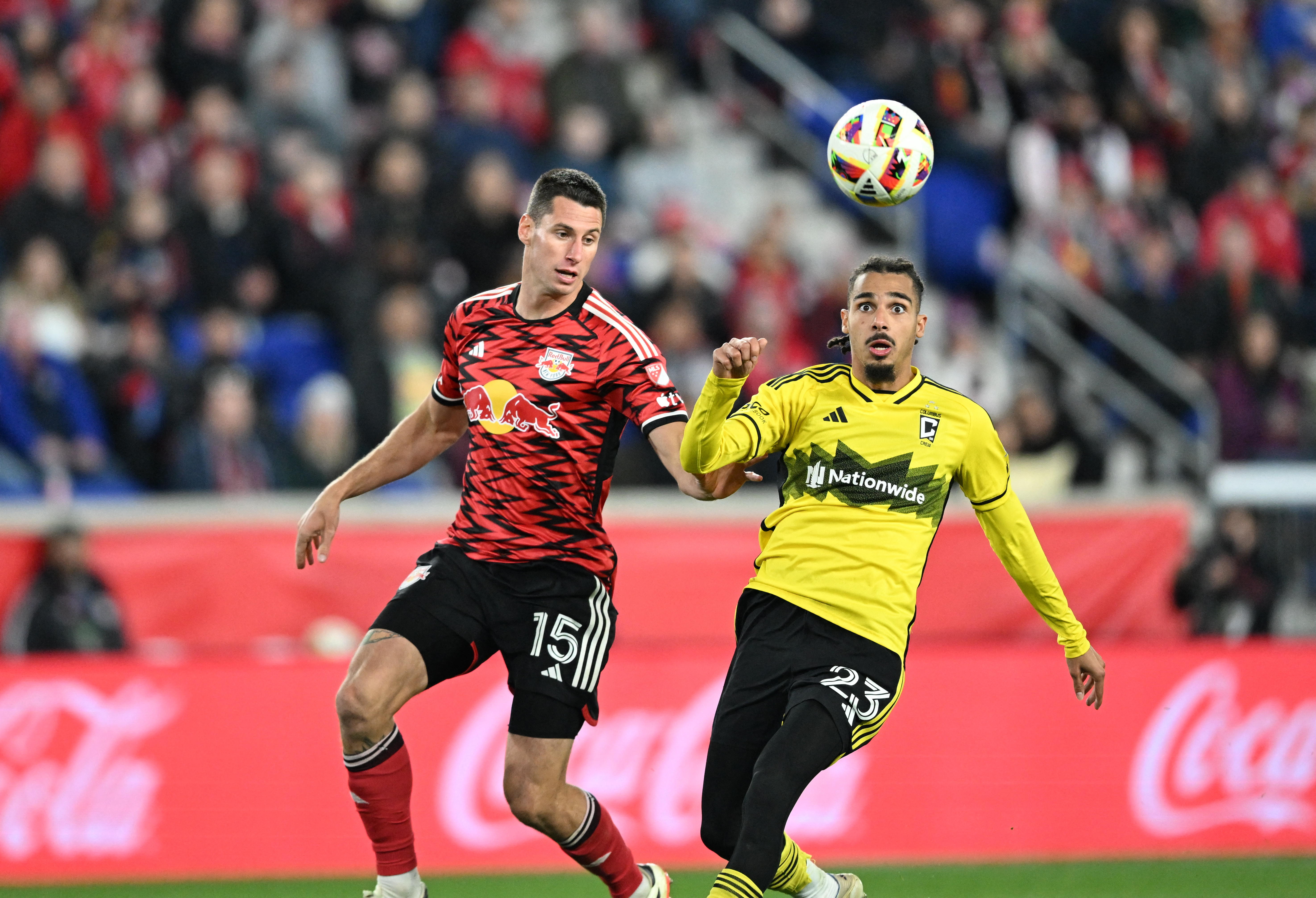 New York Red Bulls defender Sean Nealis (15) and Columbus Crew defender Mohamed Farsi (23) battle for control of the ball during the second half in a 2024 MLS Cup Playoffs Round One matchat Red Bull Arena.