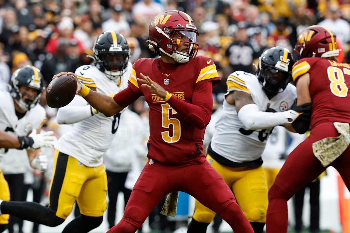 Washington Commanders quarterback Jayden Daniels (5) passes the ball as Pittsburgh Steelers linebacker Patrick Queen (6) defends during the first half at Northwest Stadium.