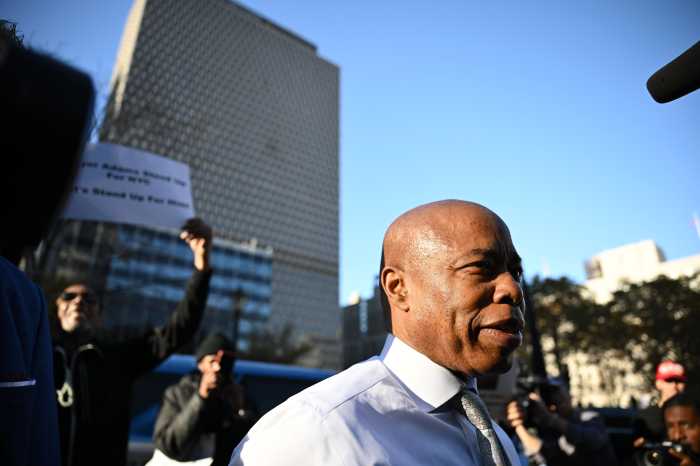 Mayor Eric Adams stands with a group of his supporters after exiting a conference in federal court. Nov. 1, 2024.