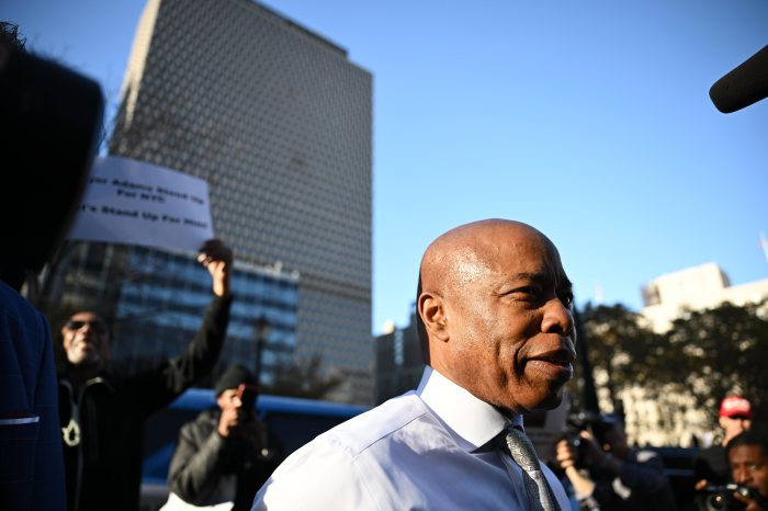 Mayor Eric Adams stands with a group of his supporters after exiting a conference in federal court. Nov. 1, 2024.