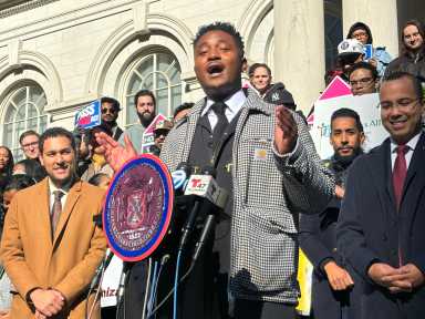 City Council Member Chi Ossé rallies with council members and advocates before the passage of his bill to relieve tenants from having to pay broker fees in most cases.