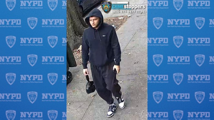 suspect wearing black hoodie and black pants walking on sidewalk 