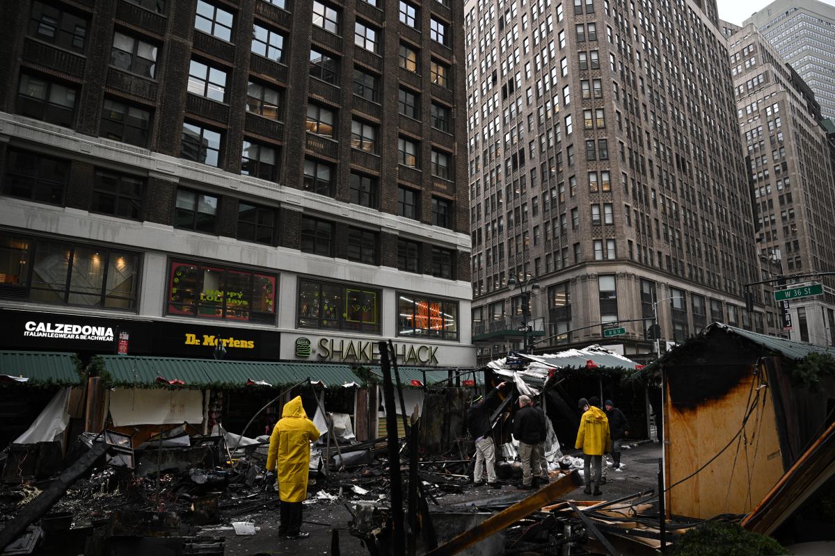 FDNY Fire Marshals probe the cause of the Herald Holiday Market.