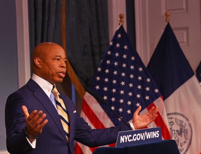 Mayor Adams throws his hands in the air when addressing his stance on immigration after meeting with Homan.