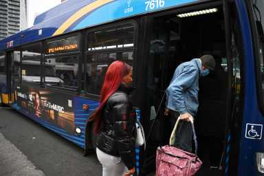 Passengers board a MTA bus in Brooklyn during the day