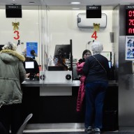 Customers at an MTA customer service center where reduced-fare OMNY is available