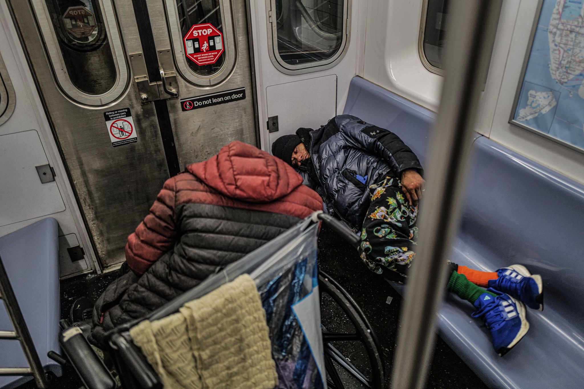 Subway safety: More cops, better lighting in stations highlighted in New York's $254 billion budget 3 Homeless individuals sleeping on a subway train in New York on Jan. 13, 2025.