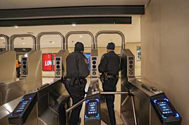 NYPD officers at subway turnstile