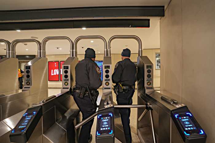 NYPD officers at subway turnstile