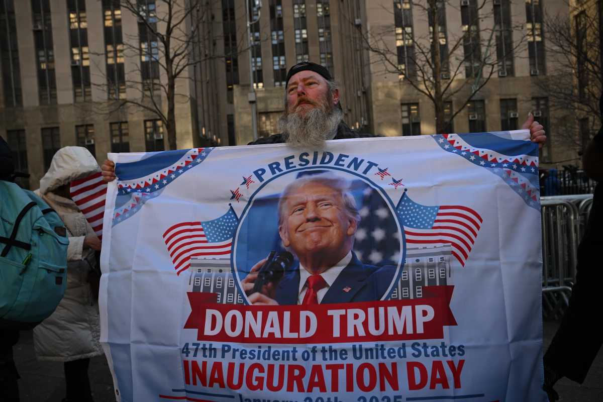 A man holding Donald Trump's banner.