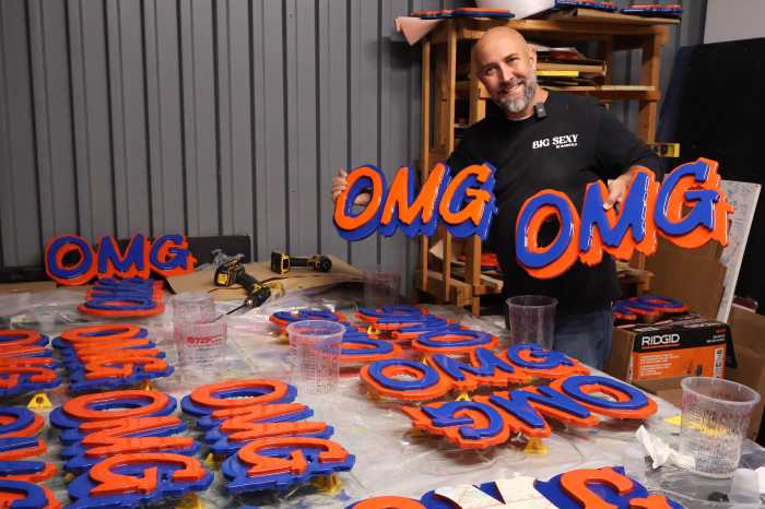 Jerome McCroy poses with his world-famous OMG signs.